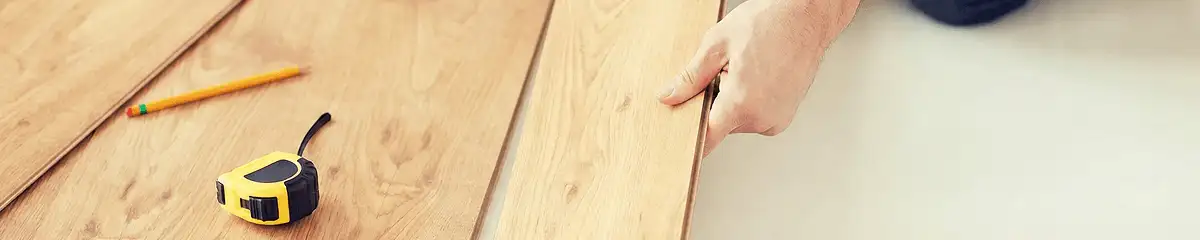 A professional installing wood flooring in Tulsa, OK