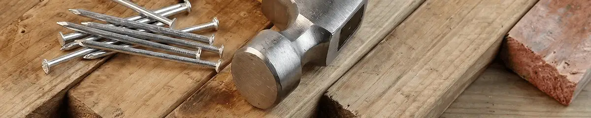 Hammer and nails on hardwood flooring boards in Tulsa, OK