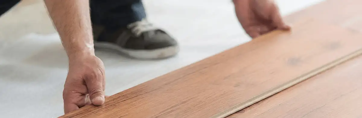 A professional installing laminate flooring in Tulsa, OK