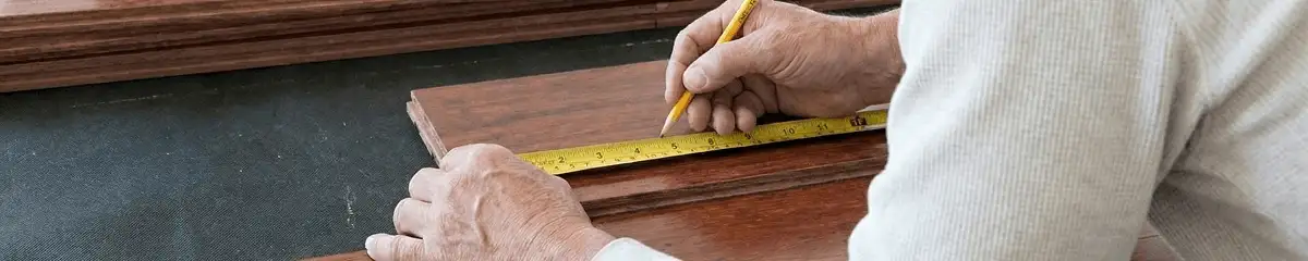 A professional installing wood flooring in Tulsa, OK